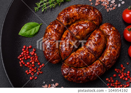 Delicious grilled sausage in the form of a ring with salt, spices and herbs 104954192