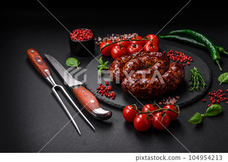 Delicious grilled sausage in the form of a ring with salt, spices and herbs 104954213