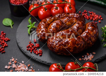 Delicious grilled sausage in the form of a ring with salt, spices and herbs Delicious grilled sausage in the form of a ring with salt, spices and herbs 104954218
