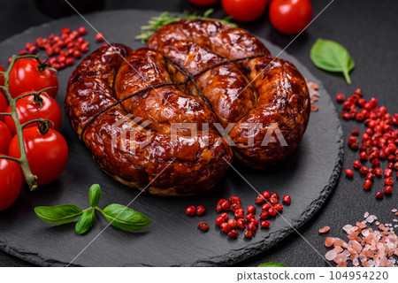 Delicious grilled sausage in the form of a ring with salt, spices and herbs Delicious grilled sausage in the form of a ring with salt, spices and herbs 104954220