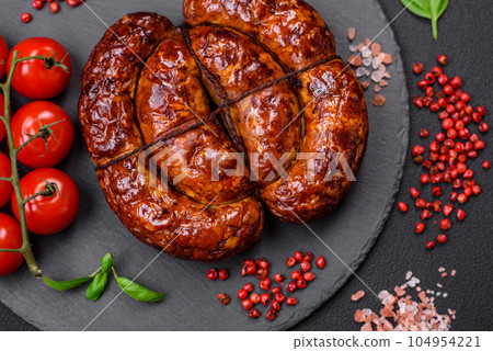 Delicious grilled sausage in the form of a ring with salt, spices and herbs 104954221