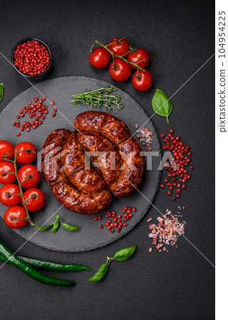 Delicious grilled sausage in the form of a ring with salt, spices and herbs Delicious grilled sausage in the form of a ring with salt, spices and herbs 104954225