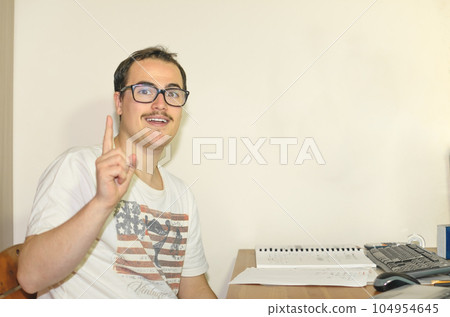 Young Man with Nerd-Style Glasses having idea pointing his finger up Young Man with Nerd-Style Glasses having idea pointing his finger up 104954645