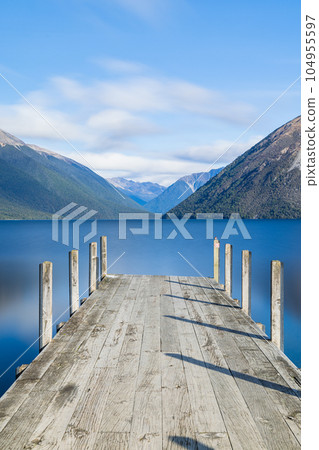 Lake Rotoiti and the Southern Alps seen from the pier in Nelson Lakes National Park, New Zealand Lake Rotoiti and the Southern Alps seen from the pier in Nelson Lakes National Park, New Zealand 104955597