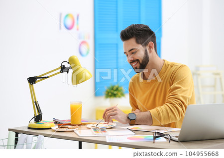 Male designer working at desk in office 104955668