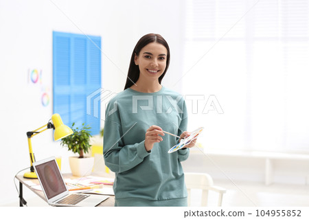 Portrait of female designer in office. Creative profession Portrait of female designer in office. Creative profession 104955852