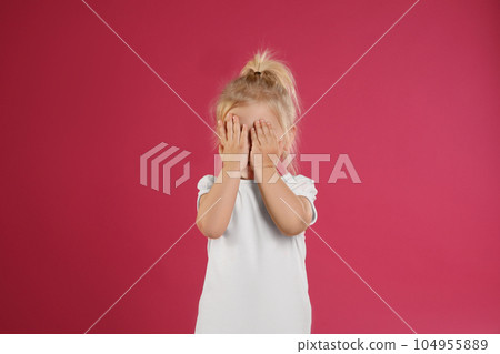 Cute little girl posing on pink background 104955889