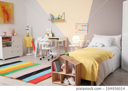 Stylish child room interior with comfortable bed and desk 104956014