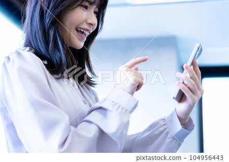 Women who use smartphones in the office Women who use smartphones in the office 104956443