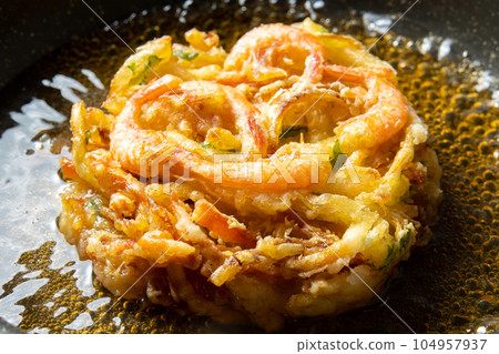 Leftover fried food remake image. A cooking scene where kakiage tempura is boiled in dashi soup to bind the egg. Leftover fried food remake image. A cooking scene where kakiage tempura is boiled in dashi soup to bind the egg. 104957937