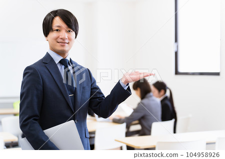 Serious Asian businessman (young man) with a personal computer in the office 104958926