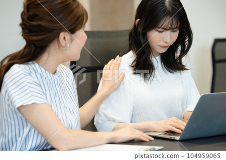 A middle-aged woman who is in a bad mood after being pointed out by a young person at a meeting A middle-aged woman who is in a bad mood after being pointed out by a young person at a meeting 104959065