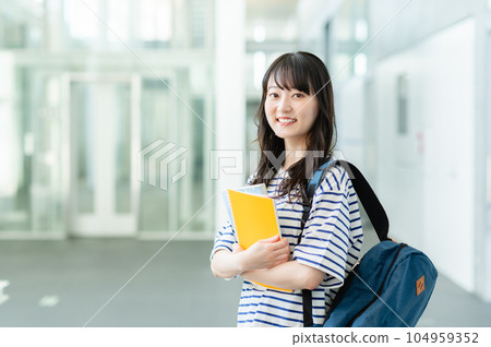 Female college student walking on campus 104959352