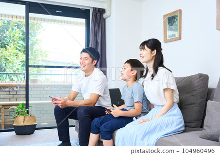 Parents and children sitting on the sofa and enjoying the game 104960496