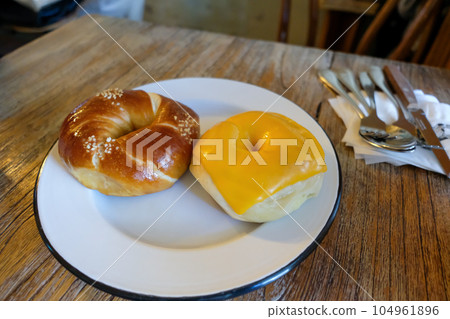 Salt and cheese bagel served on the plate Salt and cheese bagel served on the plate 104961896