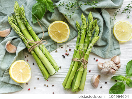 Bunch of raw asparagus stems with different spices Bunch of raw asparagus stems with different spices 104964604