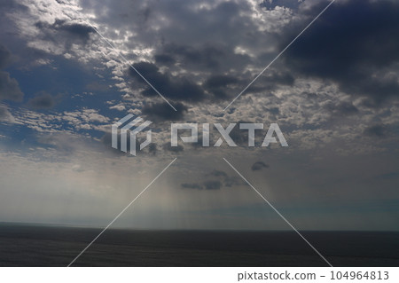 Cloudy sky, sunlight, sea, dark Cloudy sky, sunlight, sea, dark 104964813