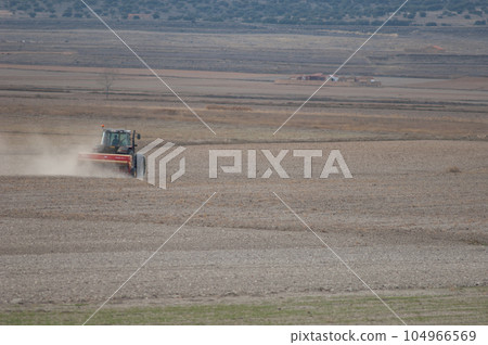 Tractor working in the field. Tractor working in the field. 104966569