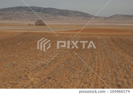 Ploughed field. Ploughed field. 104966574