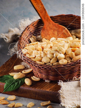 Peeled peanuts in wicker bowl. Village still life. Advertising photo of nuts for online store or Peeled peanuts in wicker bowl. Village still life. Advertising photo of nuts for online store or 104966646