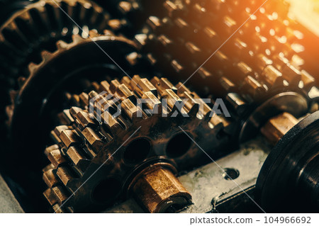 Mechanism gears in machine oil close-up. Gearbox repair. Background. Cinematic toning. Mechanism gears in machine oil close-up. Gearbox repair. Background. Cinematic toning. 104966692