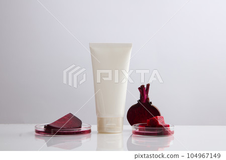 Minimal scene of a cosmetic container with glass petri dishes containing beetroot slices. Beetroot (Beta vulgaris) can help you treat pigmentation 104967149