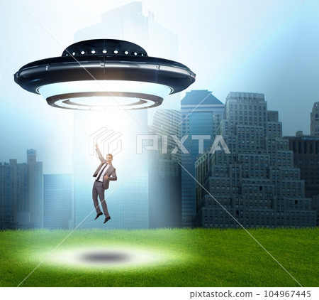 Flying saucer abducting young businessman Flying saucer abducting young businessman 104967445
