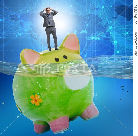 Businessman in debt concept with piggybank Businessman in debt concept with piggybank 104967886