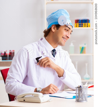 Young male doctor otolaryngologist working at the hospital 104968600
