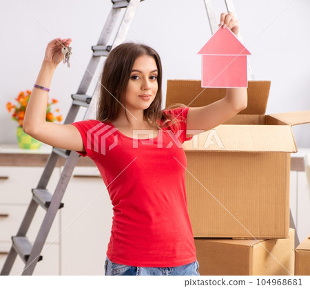 Young beautiful woman moving to new flat Young beautiful woman moving to new flat 104968681
