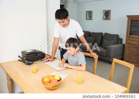 Parents and children studying in the living room 104969161