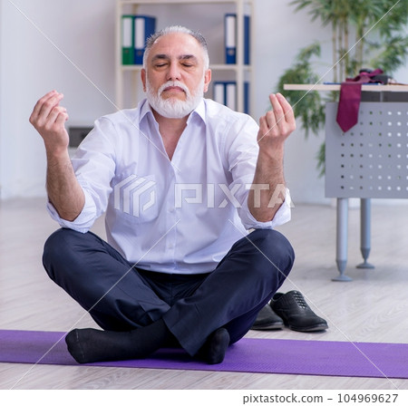 Aged male employee doing physical exercises during break Aged male employee doing physical exercises during break 104969627