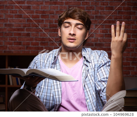 Young handsome student preparing for exams at night 104969628
