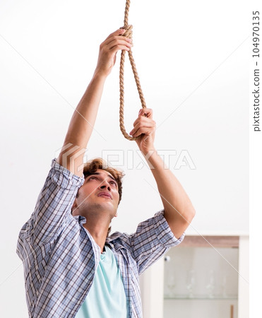 Young man preparing to commit suicide by hanging Young man preparing to commit suicide by hanging 104970135