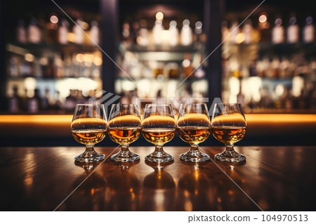 Glasses of whiskey with ice on the bar Glasses of whiskey with ice on the bar 104970513