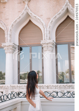 Beautiful lady watching the famous hotel in Las Vegas, standing in the busy city. Famous tourist attraction in USA on vacation in Las Vegas. Beautiful lady watching the famous hotel in Las Vegas, standing in the busy city. Famous tourist attraction in USA on vacation in Las Vegas. 104970913