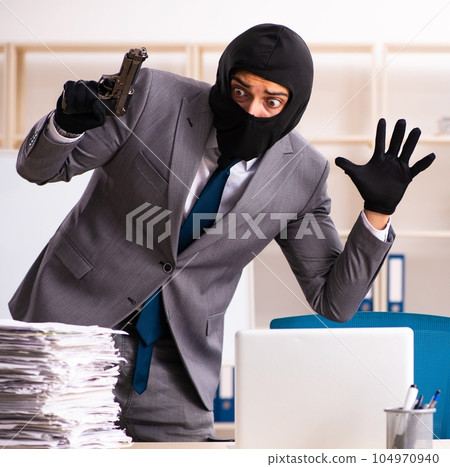 Male gangster stealing information from the office 104970940