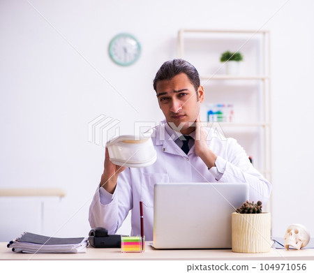 Young male doctor traumatologist working in the clinic 104971056