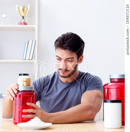 Athlete tasting new protein supplements for better muscles Athlete tasting new protein supplements for better muscles 104971516