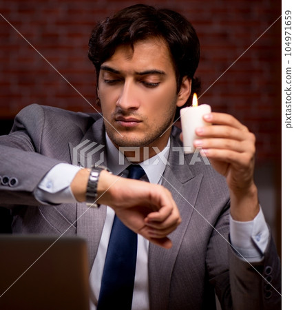 Businessman working late in office with candle light Businessman working late in office with candle light 104971659