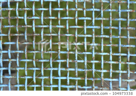 Iron painted mesh. Blue metal mesh close-up. iron fence. 104973338