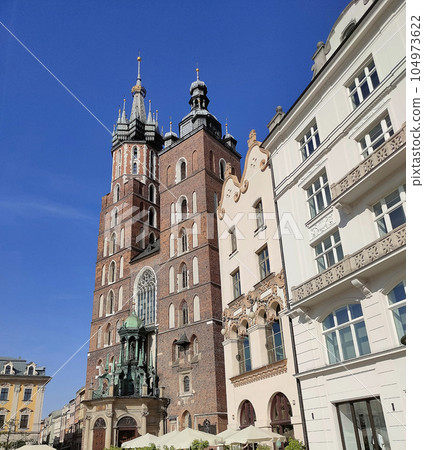 Krakow, Poland - Facade of the St. Mary's Church in the main square of Krakow, on a sunny day Krakow, Poland - Facade of the St. Mary's Church in the main square of Krakow, on a sunny day 104973622