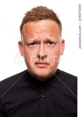 Close up portrait of a confident, blond, handsome young man wearing black shirt, isolated on white background Close up portrait of a confident, blond, handsome young man wearing black shirt, isolated on white background 104974097