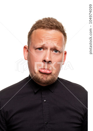 Close up portrait of a confident, blond, handsome young man wearing black shirt, isolated on white background 104974099