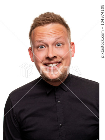 Close up portrait of a confident, blond, handsome young man wearing black shirt, isolated on white background 104974109