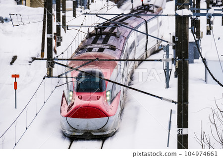 Akita Shinkansen "Komachi" departing from Kakunodate Station in the snow 104974661