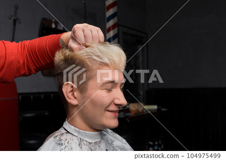 Smiling guy handsome young european appearance with closed eyes portrait white hair hairdresser client 104975499