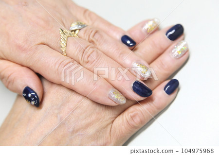 Dark blue with rhinestones and gold glitter nail deco Dark blue with rhinestones and gold glitter nail deco 104975968