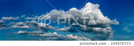 Fluffy clouds on a clear sunny day Fluffy clouds on a clear sunny day 104976733