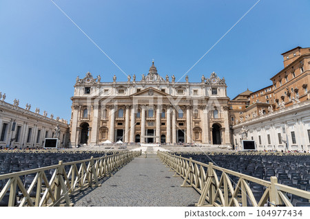 Saint Peter's Square is a large plaza located directly in front of St. Peter's Basilica in Vatican City. Chairs are prepared for mass and general audience. Saint Peter's Square is a large plaza located directly in front of St. Peter's Basilica in Vatican City. Chairs are prepared for mass and general audience. 104977434